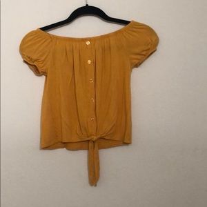 Yellow crop top, off the shoulder shirt.